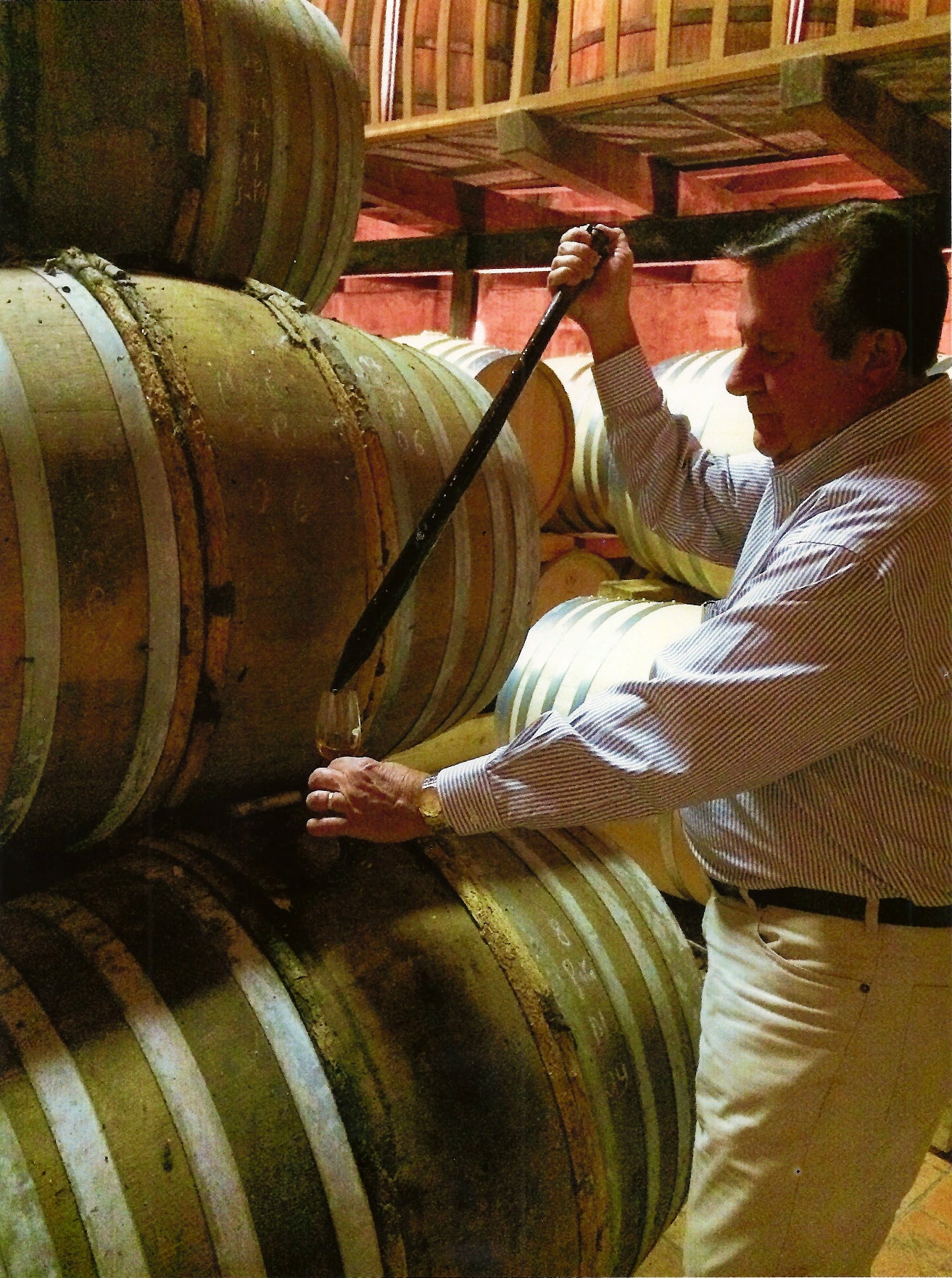 A present-day J.W. Kelly brand steward working beside a whiskey barrel